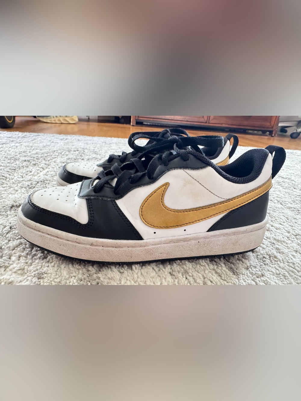 Nike Kids Low-Top Sneakers in Black, White & Gold Swoosh